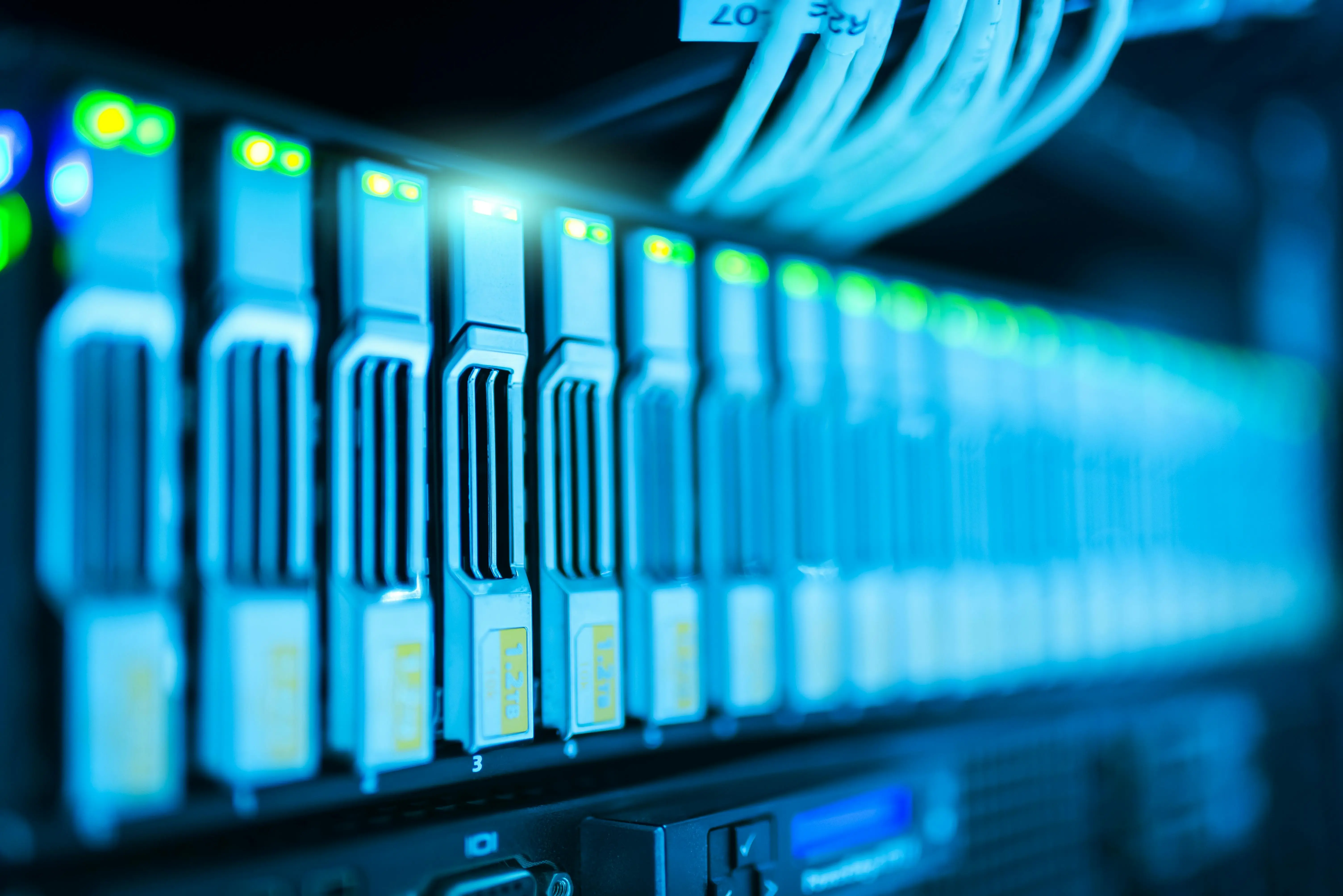 Row of blue-lit blade servers in a hyperscale data centre — G.657.A2 bend-insensitive fiber is specified for high-density AI and cloud computing environments