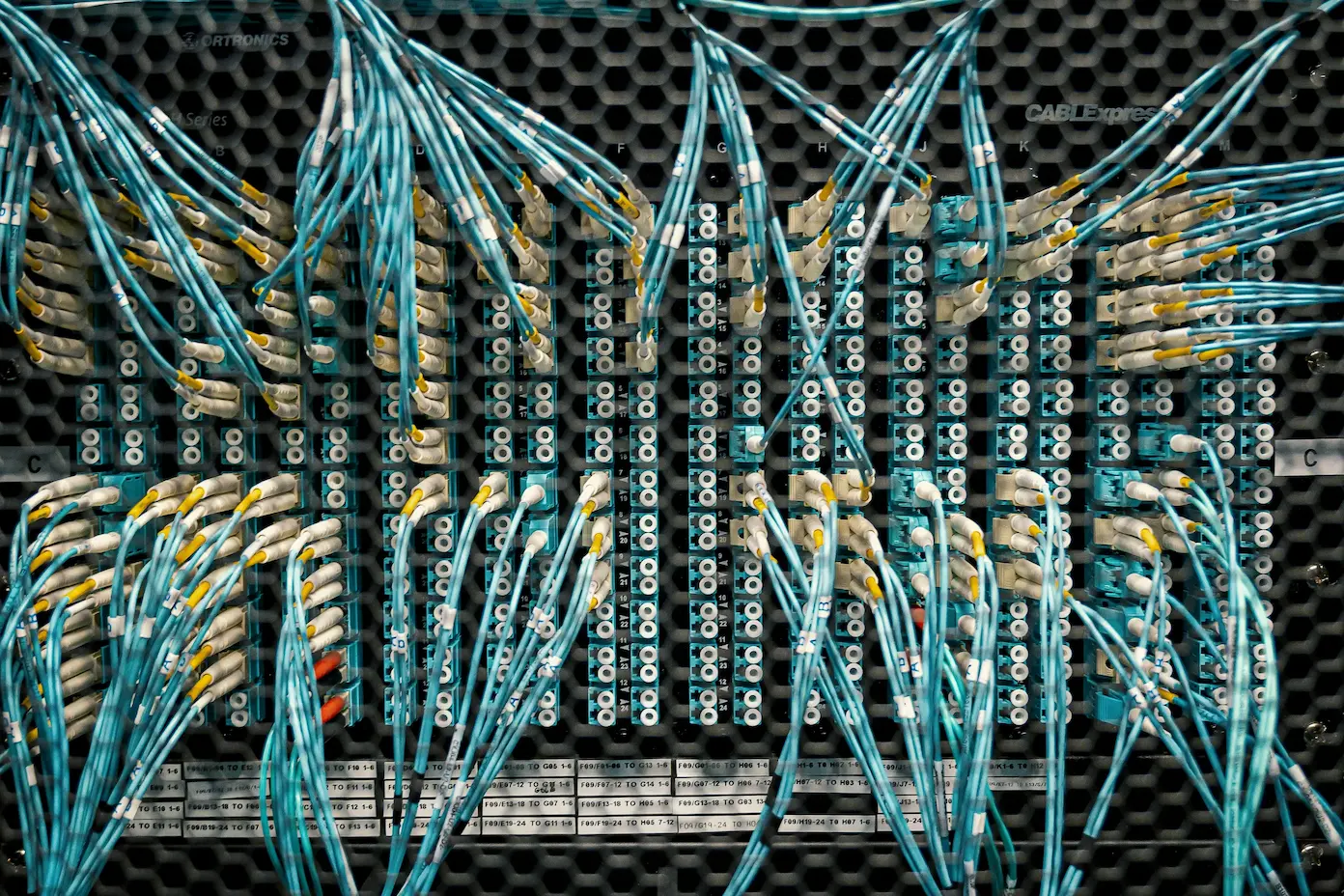 Dense fiber optic patch panel with G.657.A2 bend-insensitive cables routed through a high-density data centre cross-connect