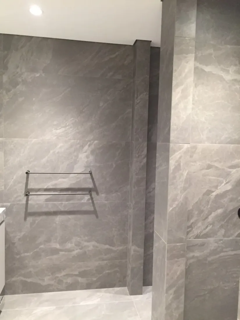 Stone-tiled bathroom in a luxury apartment complex in Ireland, fitted out with interior finishes sourced through Ériu