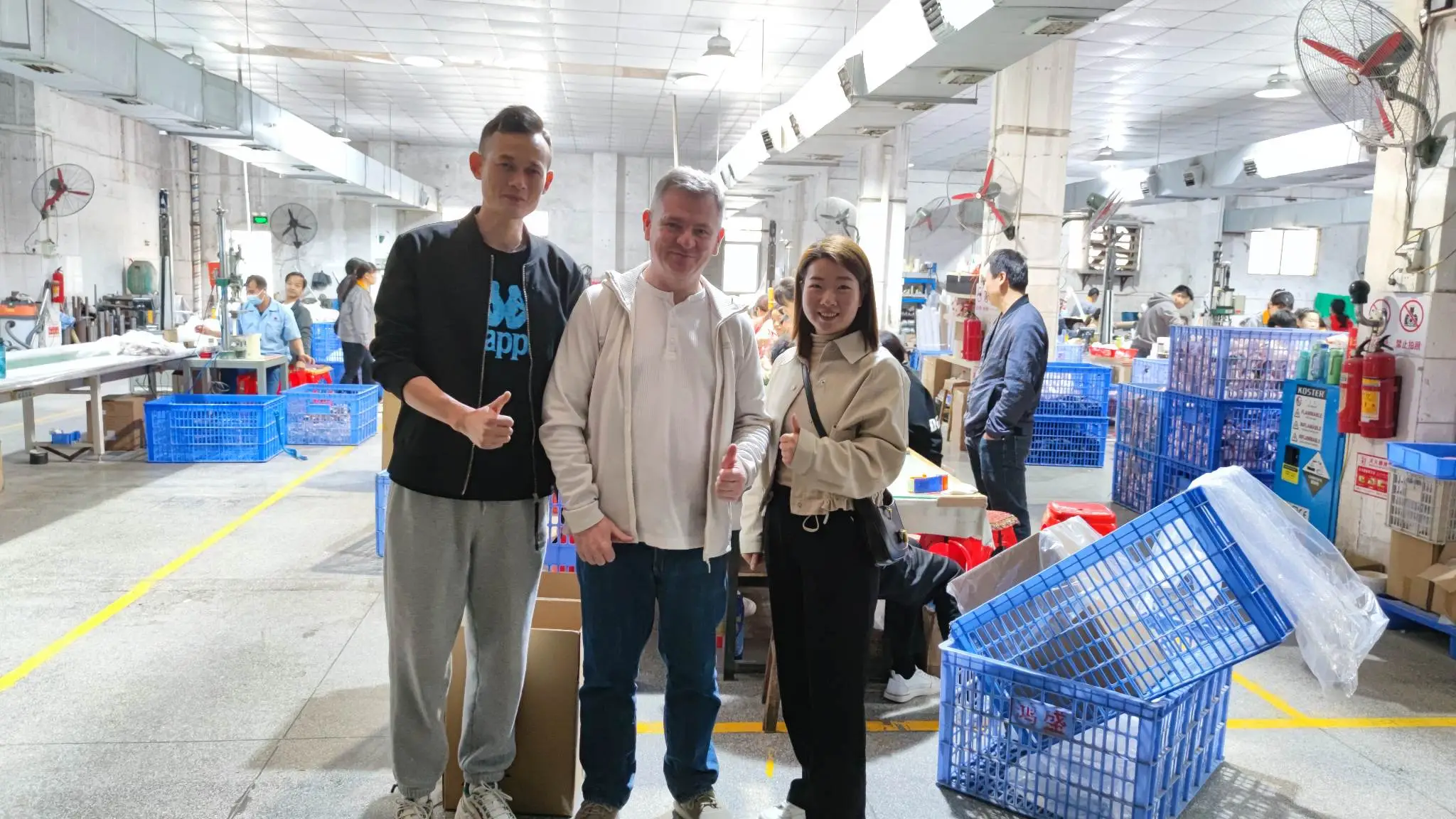 Noel with factory team on production floor in Dongguan during inspection